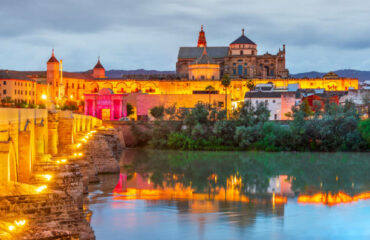 Cordoba, Spain. Mezquita - Great Mosque and Roman Bridge on Guadalquivir, sunset scene in Andalusia.